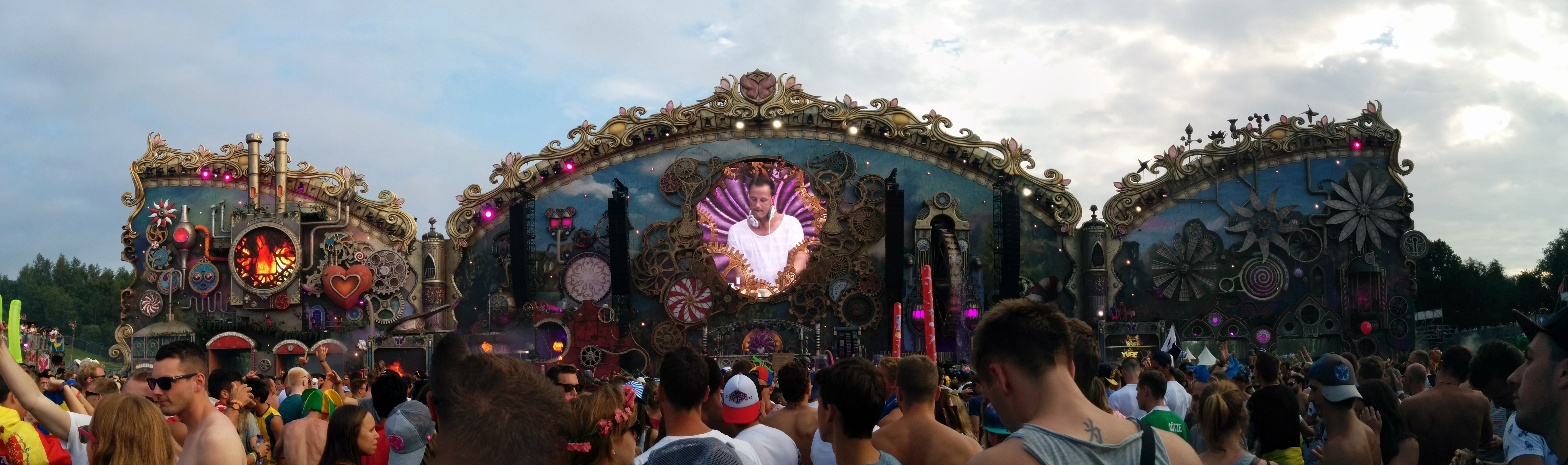The illuminated main stage of Tomorrowland with a festival crowd