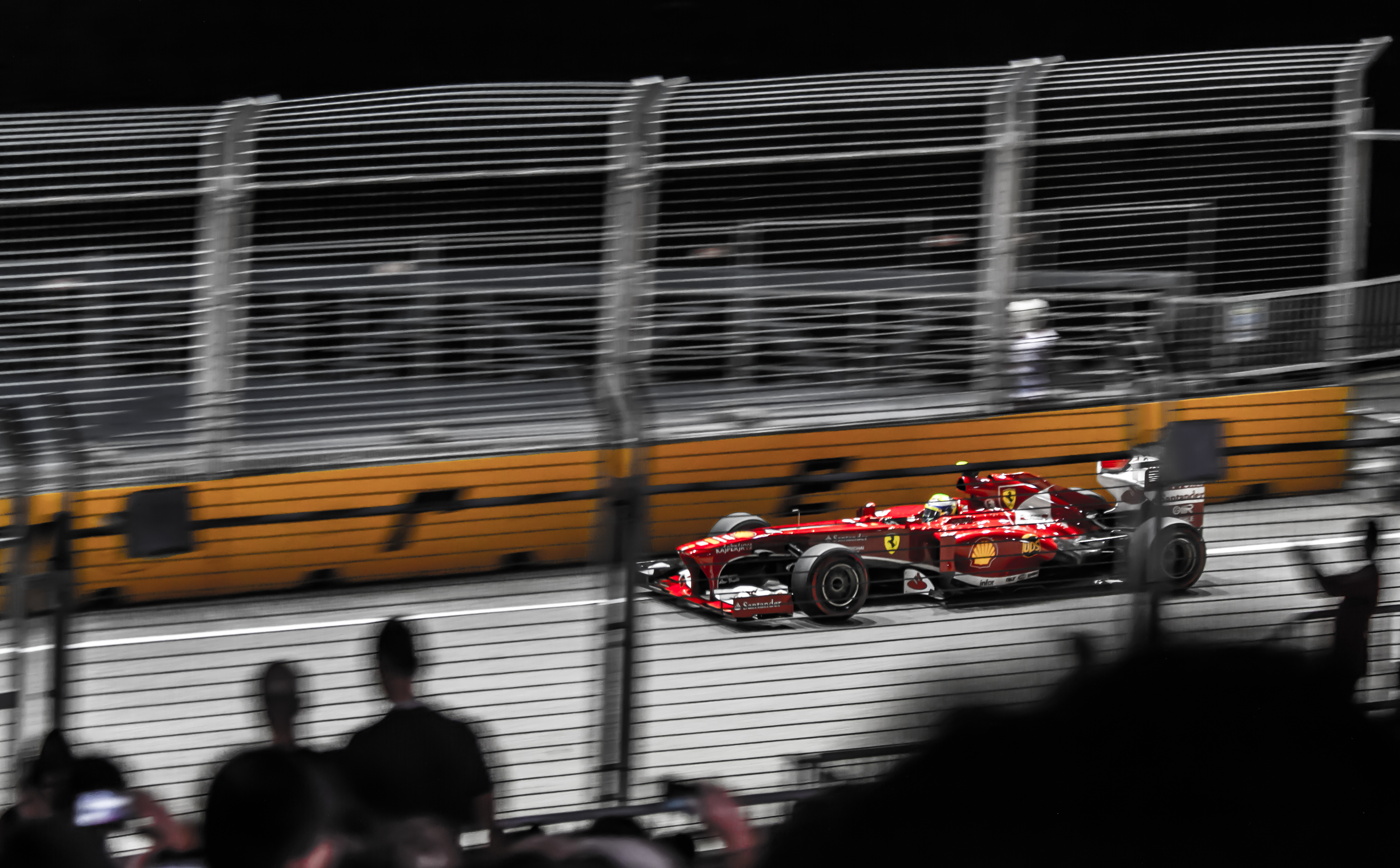 A Formula 1 car racing under floodlights at the Singapore Grand Prix night street circuit
